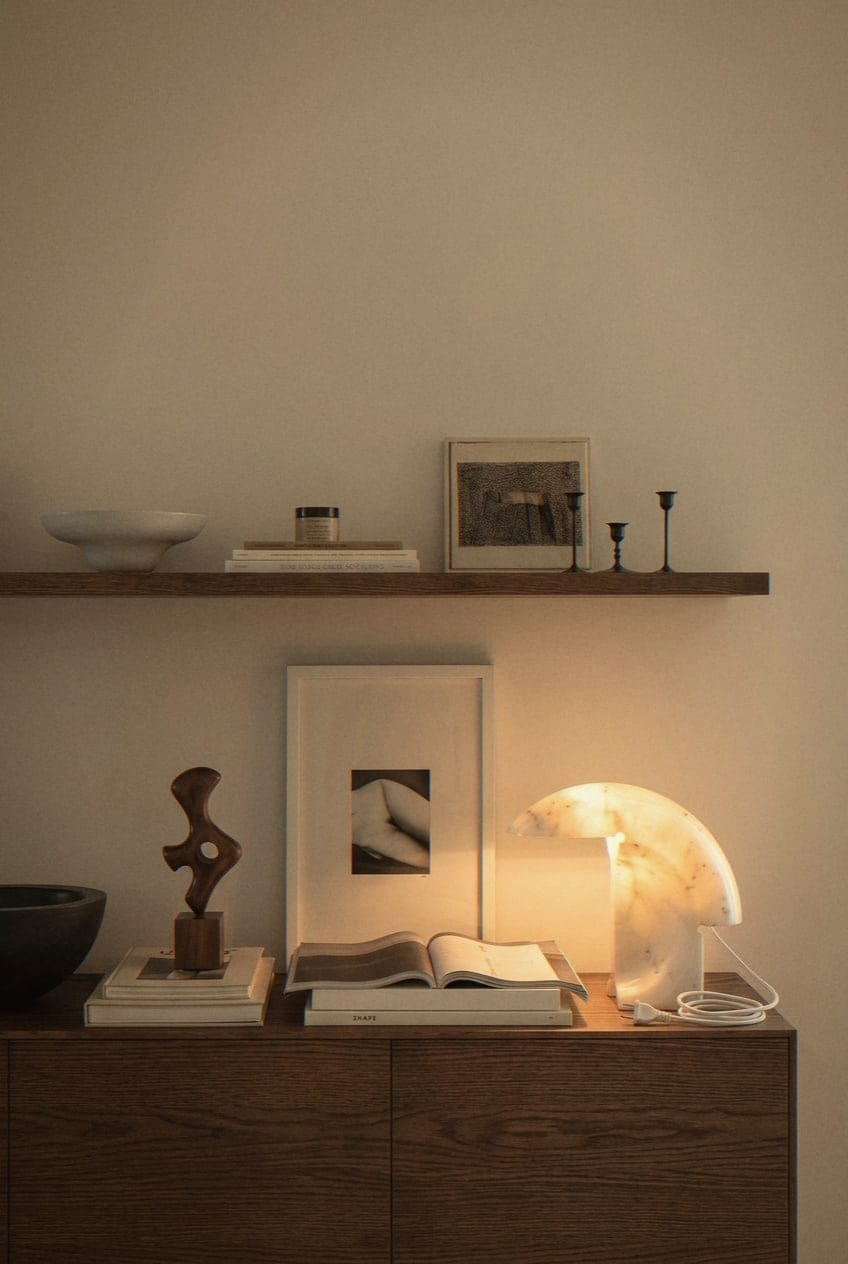 Styled walnut sideboard with sculpture and lamp