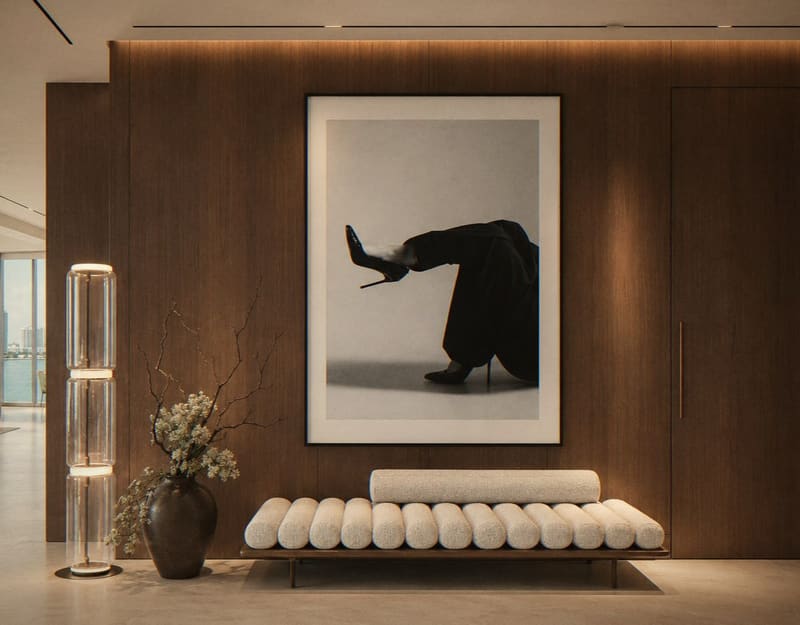 Entrance with walnut wall, bouclé bench and black and white photograph